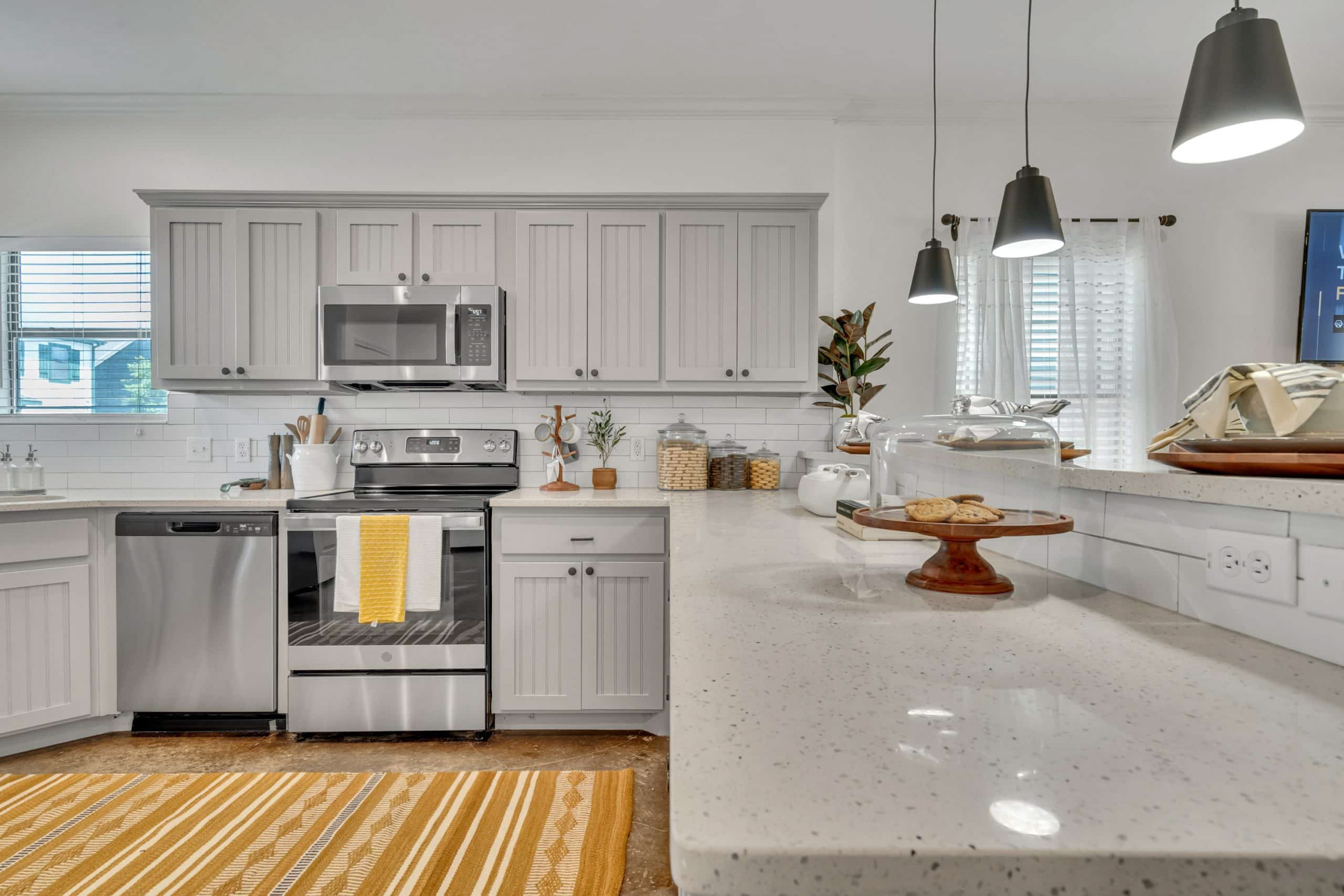 Kitchen with gray counter tops and yellow decor